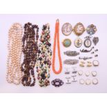 A box of various jewellery including gold rings, beaded necklaces, brooches, etc.