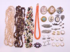 A box of various jewellery including gold rings, beaded necklaces, brooches, etc.
