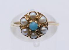 A 9 ct gold seed pearl and turquoise ring. Ring size M. 2.3 grammes total weight.