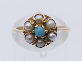 A 9 ct gold seed pearl and turquoise ring. Ring size M. 2.3 grammes total weight.