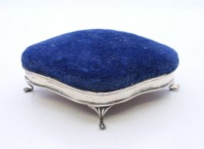 A silver pin cushion, hallmarked for Birmingham 1909. 10 cm x 7 cm.