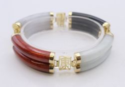 A large Chinese bracelet set with 14 ct gold. 19 cm long.