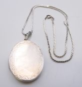 A large silver double photo locket on silver chain. The locket 4.5 cm high. 28.