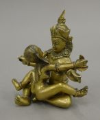 An Indian erotic bronze. 12 cm high.