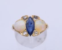 A Victorian 18 ct gold sapphire, opal and diamond ring. Ring size Q. 5.7 grammes total weight.