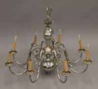An eight-branch silvered brass chandelier. 62 cm high.