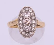 An 18 ct gold diamond set oval cluster ring. Ring size N. 4.3 grammes total weight.