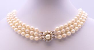 A three strand pearl necklace with a 9 ct gold clasp. 41 cm long.
