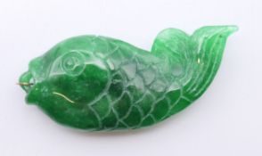 A gold mounted jade fish shaped pendant. 6.5 cm high.