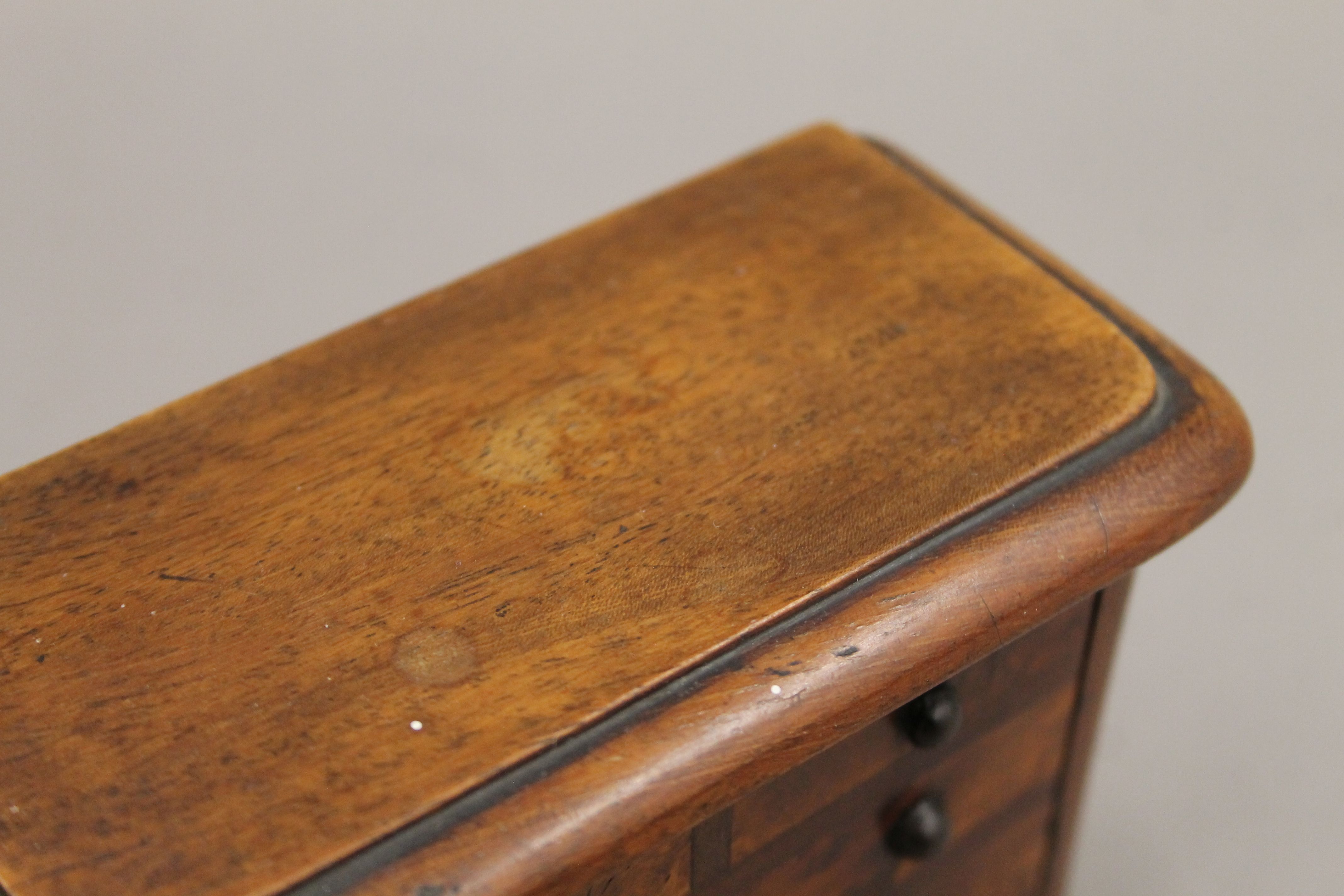 A money box formed as a Victorian chest of drawers. 12.5 cm wide. - Image 4 of 4