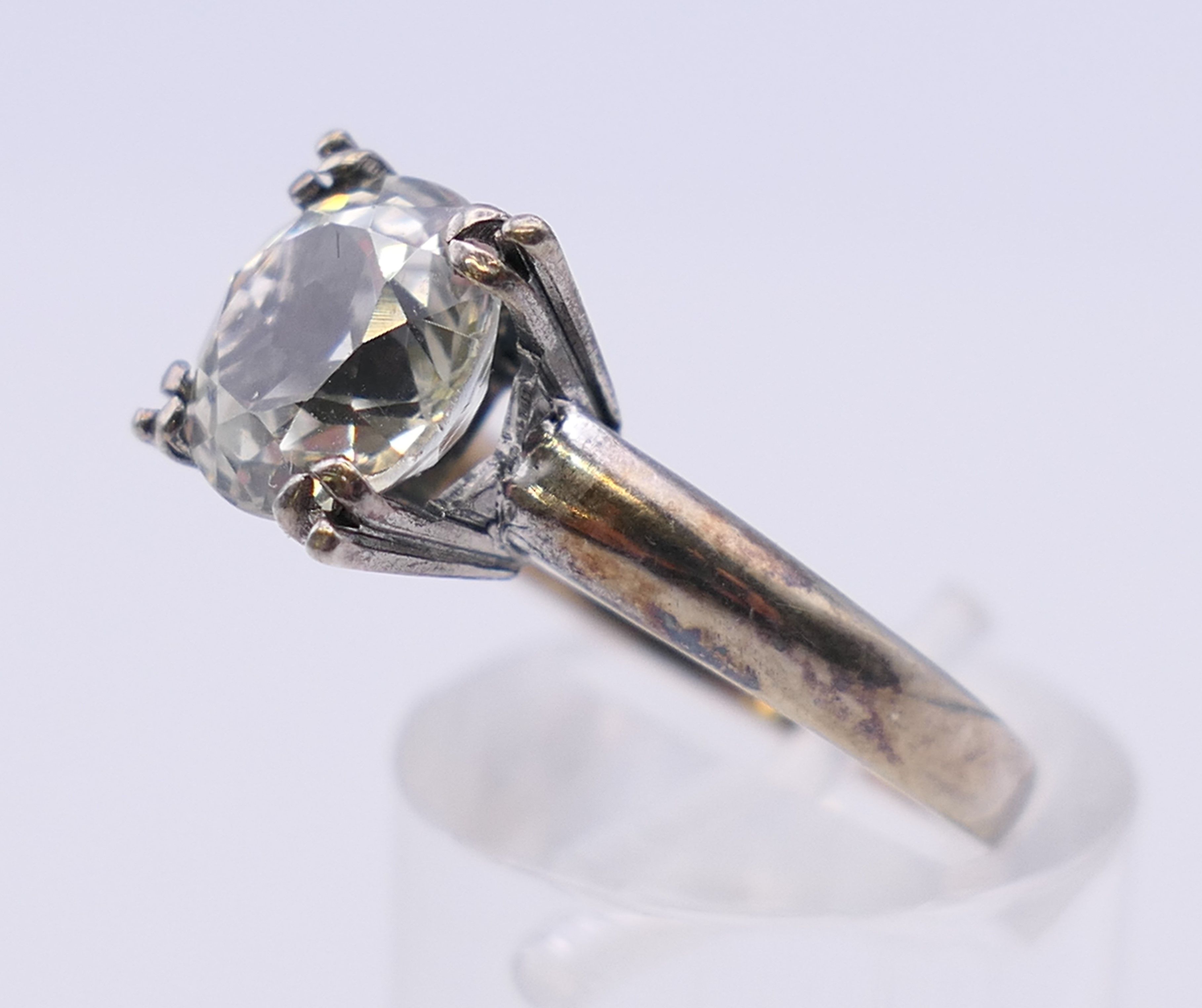 An unmarked solitaire ring, possibly white sapphire. Ring size M/N. - Image 2 of 4