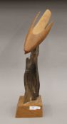 A wooden carving of a Peregrine Falcon. 60 cm high.