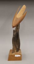 A wooden carving of a Peregrine Falcon. 60 cm high.