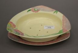 A Clarice Cliff plate and drainer dish. The former 21.5 cm wide.