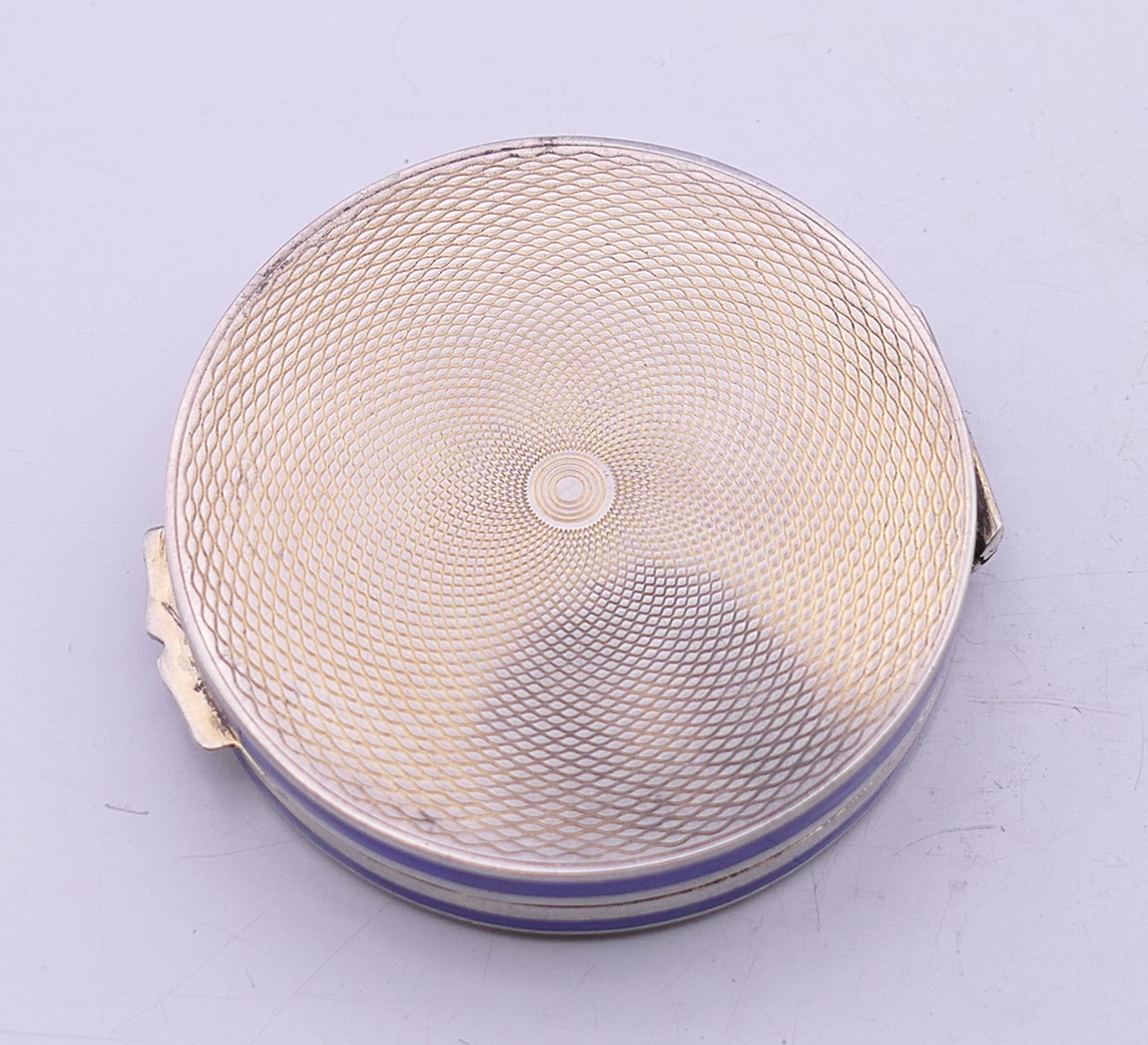 An enamel decorated silver compact. 5 cm diameter. - Image 5 of 6