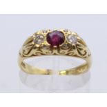 An 18 ct gold ruby and diamond ring. Ring size N/O. 5 grammes total weight.