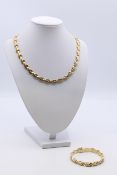 A 9 ct gold necklace and matching bracelet. Necklace 44 cm long, bracelet 19 cm long. 38.1 grammes.