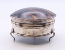 A tortoiseshell lidded silver jewellery box. 7 cm diameter.