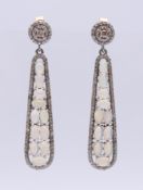 A pair of opal and diamond drop earrings. 4.5 cm high.