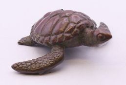 A bronze model of a turtle. 5 cm x 6.25 cm.