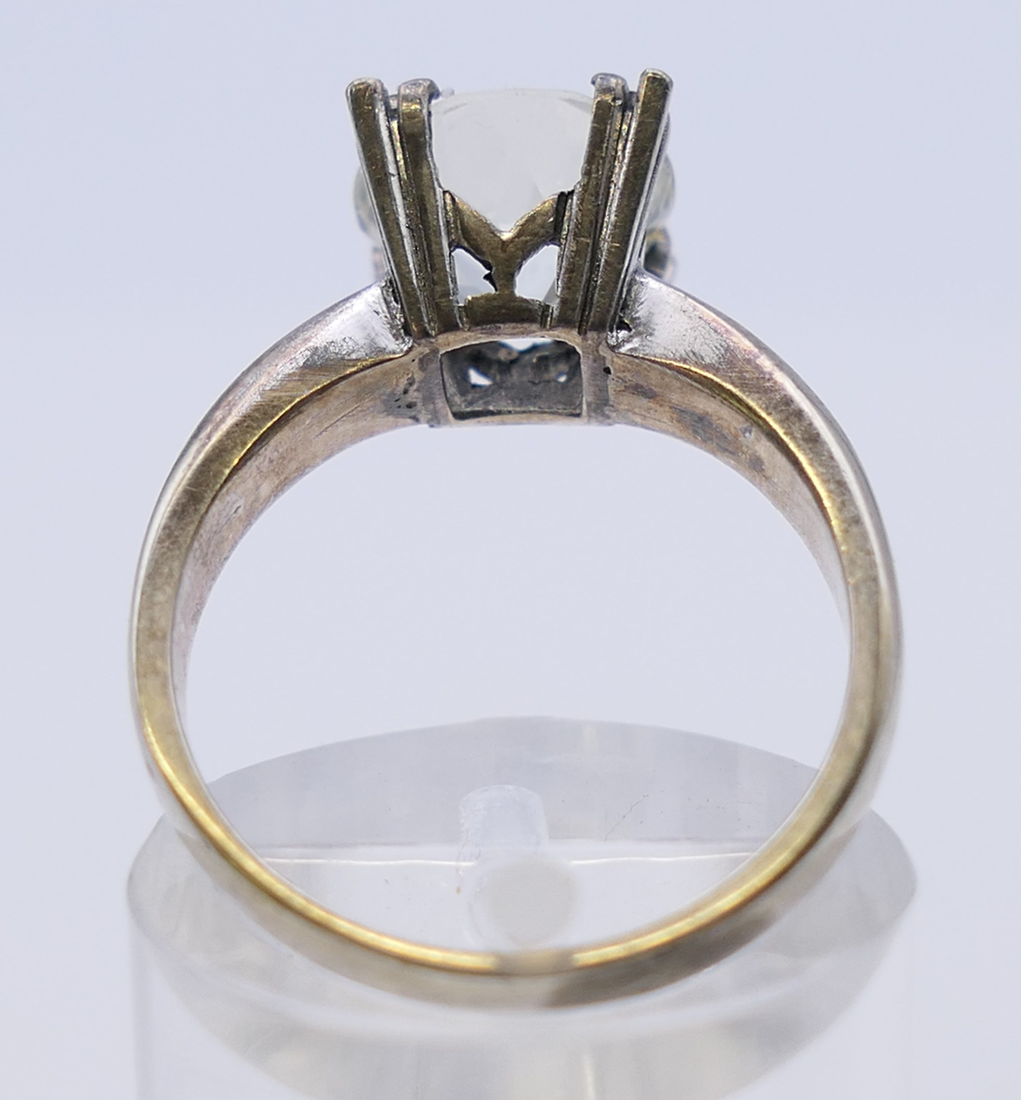 An unmarked solitaire ring, possibly white sapphire. Ring size M/N. - Image 4 of 4