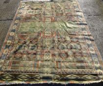 A large green ground rug. 325 cm x 225 cm.