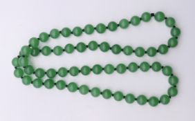A string of jade beads. 68 cm long.