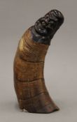 A horn carved as Buddha. 23.5 cm high.