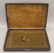 A cased set of Chinese decorative place mats. The box 40 cm wide.