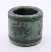 An engraved jade archer's ring. 3 cm high.