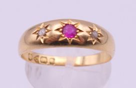 An 18 ct gold diamond and ruby gypsy set ring. Ring size Q/R. 3.6 grammes total weight.