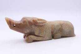 A Chinese white and russet jade pig, Han Dynasty. 8.5 cm long.