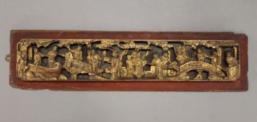 A Chinese gilt heightened carved wooden panel. 64 cm long.