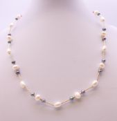 A 9 ct gold two tone pearl necklace. 44 cm long.