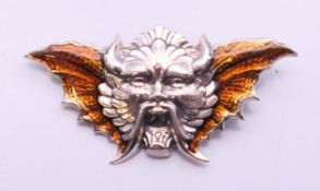A silver devil's head shaped brooch. 5.5 cm wide.