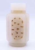 A Chinese light pink and white reticulated jade snuff bottle (stopper missing), Qing Dynasty. 6.