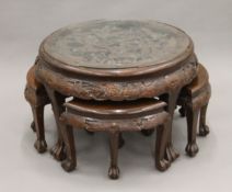 An early 20th century Eastern carved wooden nest of coffee tables. 77 cm diameter.