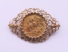 A 1911 gold sovereign mounted as a brooch. 4 cm x 2.5 cm. 8.9 grammes total weight.