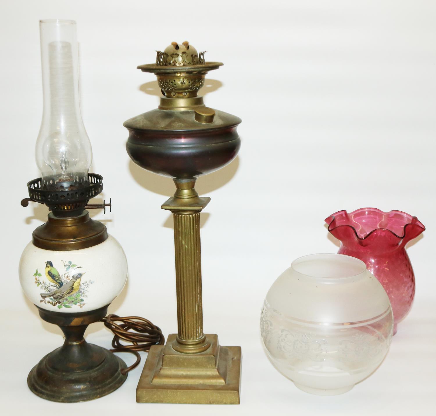 Two early 20th century oil lamps: one converted to electric, with ceramic body decorated with birds,
