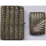 White metal five tube cigarette case with a floral design and vesta case with shell and floral