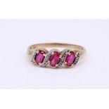 9ct gold three stone ruby and diamond crossover ring, size T, 2.0 g