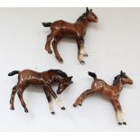 Group of Beswick models - large head down foal in brown gloss, model no. 947, large Shire foal in