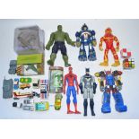Collection of toys and models including a Transformer and superhero action figures, Lego Bionicle