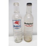 Two Mobil oil glass oil bottles, one with bottle cap
