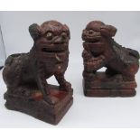 Pair of Chinese carved wooden Dog of Foe candlesticks, on rectangular base, later painted with