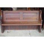 Small Victorian pitch pine pew, twin panelled back on solid shaped end, W160cm D50cm H84cm