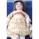 Koppelsdorf doll stamped 250-9, brown wig, wearing a cream and pink dress with sash, straw hat,
