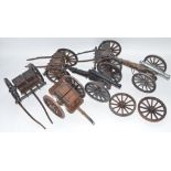 Two large cannon models in metal and wood with ammunition tenders and a pair of spare wheels.