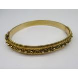 15ct yellow gold bangle with beaded detail and safety chain, stamped 15, 16.8g