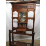 Edwardian oak hall stand, raised back with carved frieze and shield shaped bevelled mirror, Art